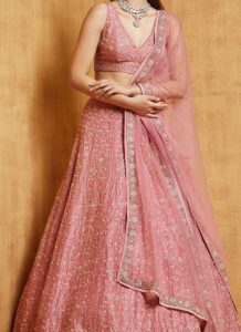 Traditional pink embroidered satin lehenga wedding wear closeup view